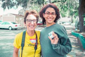 A young client celebrates her new ID with an IDignity volunteer