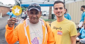 An IDignity client shows of his new REAL ID.